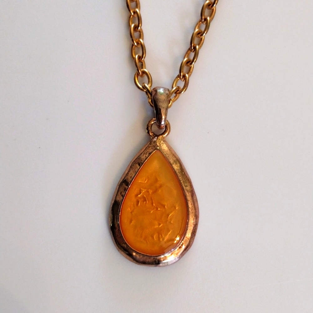 KC teardrop shaped pendant necklace.
